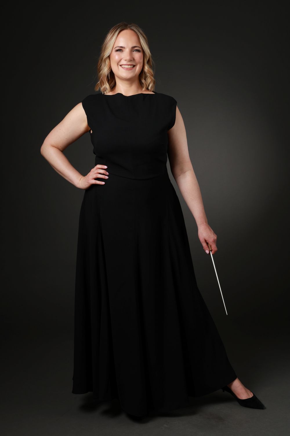 Full length headshot of Joanna Tomlinson with baton